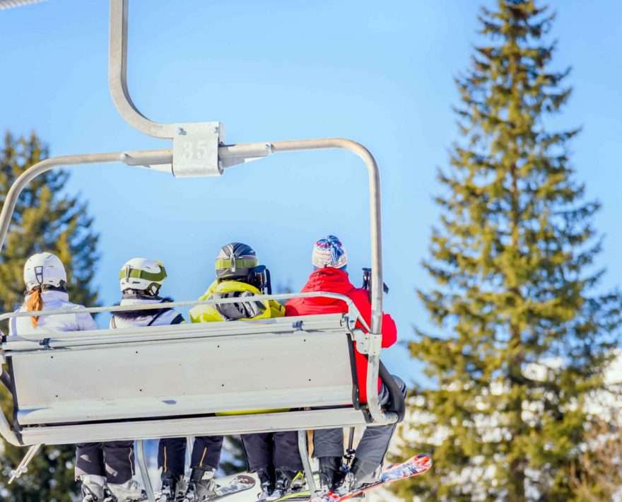 A group of skiers on a chair life in Vermont