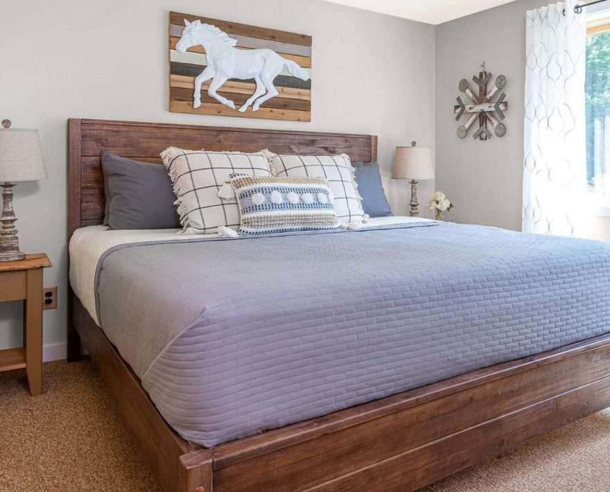 King bed with artwork oof a horse over it at White Horse Lodge in Vermont