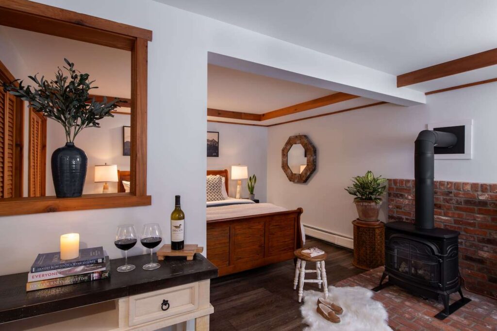 A King honeymoon suite with a wood burning fireplace at our Vermont Lodging