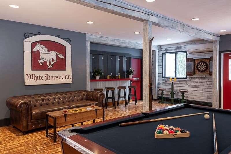 A pool table and seating area in the game room at our Vermont lodge